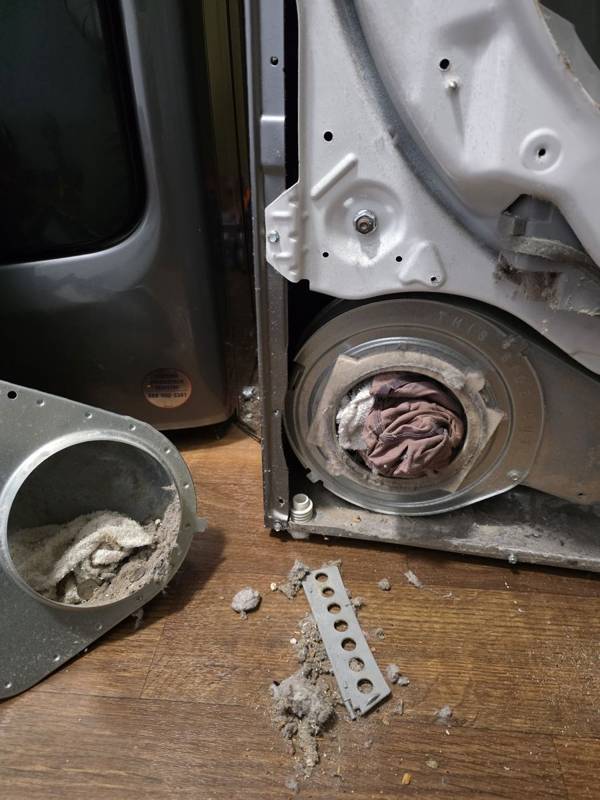 Dryer blower housing clogged with clothing and lint, found during a dryer repair in Douglas, GA