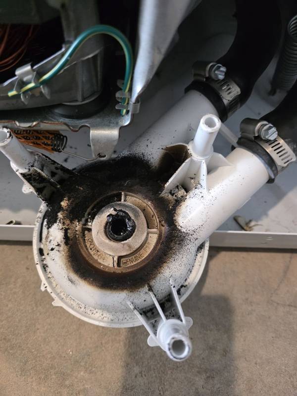 Worn-out washer drain pump removed during a washer repair in Douglas, GA